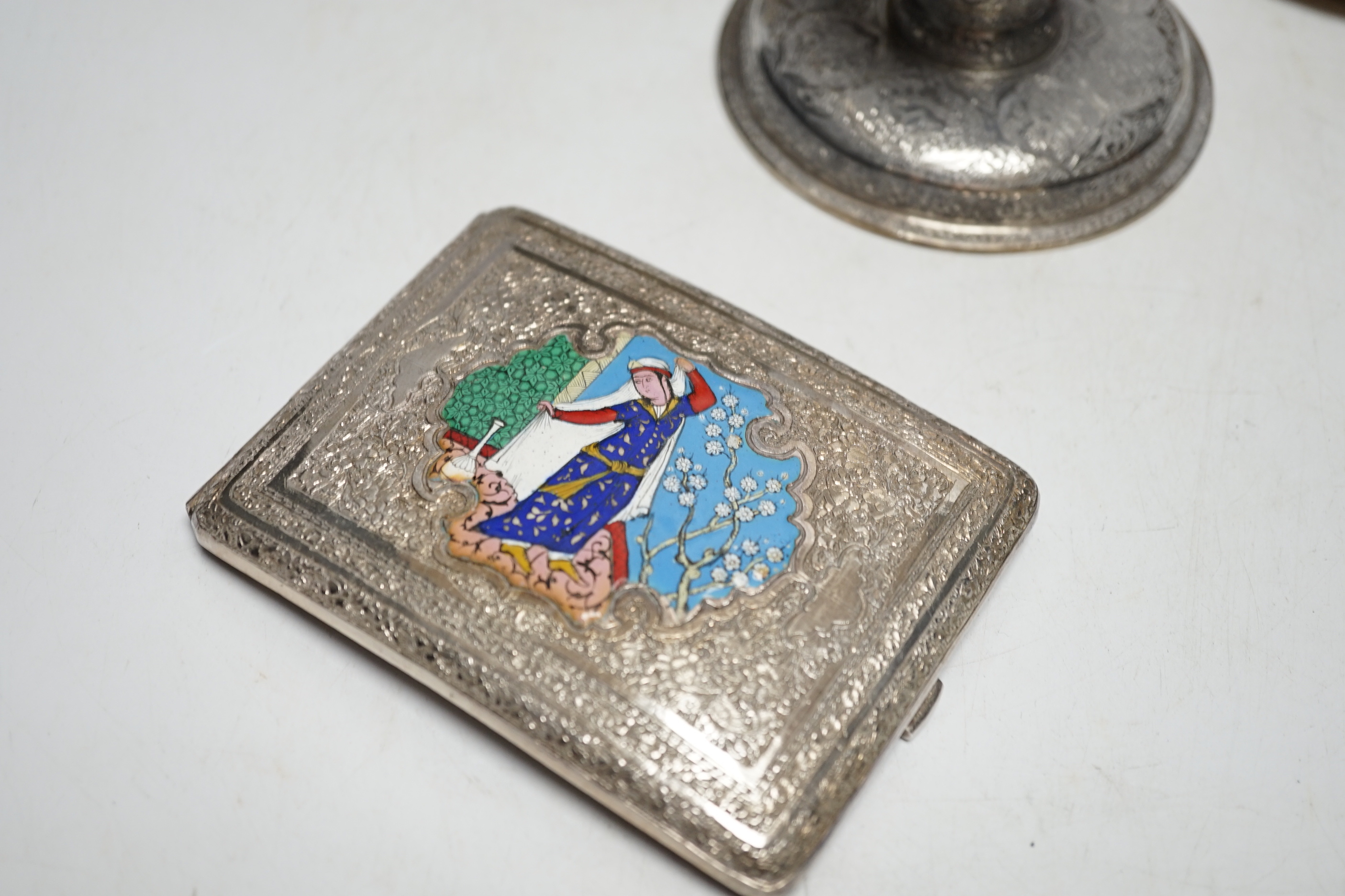 Three Persian white metal dwarf candlesticks including a pair, base 88mm, a similar white metal and enamelled cigarette case and a Persian metal vase.